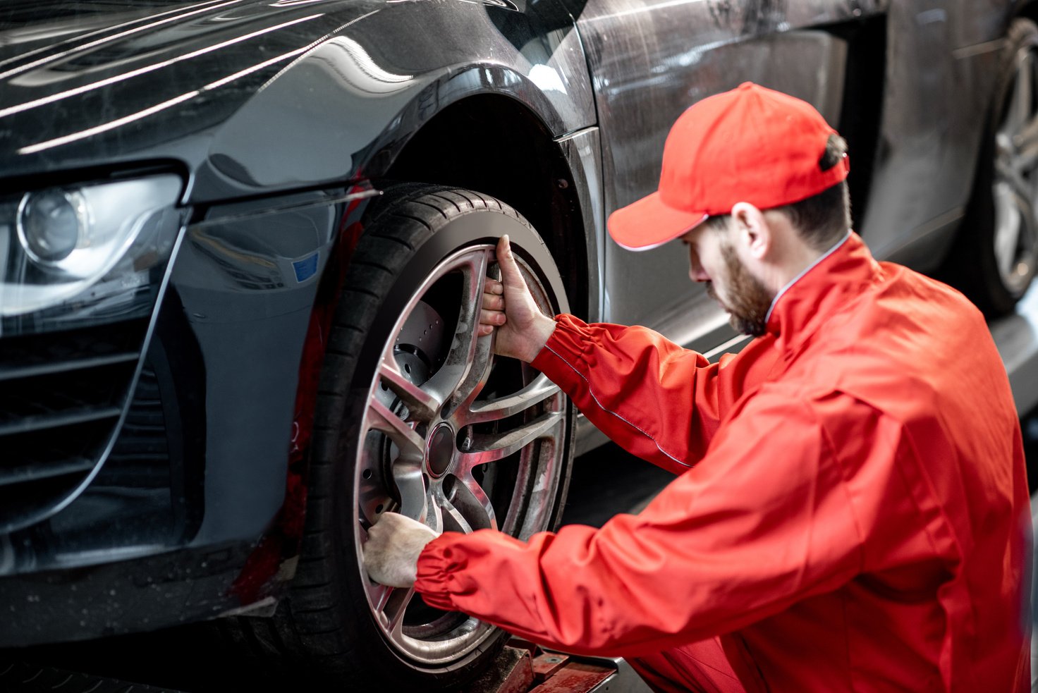 Car Service Worker Changing Wheel